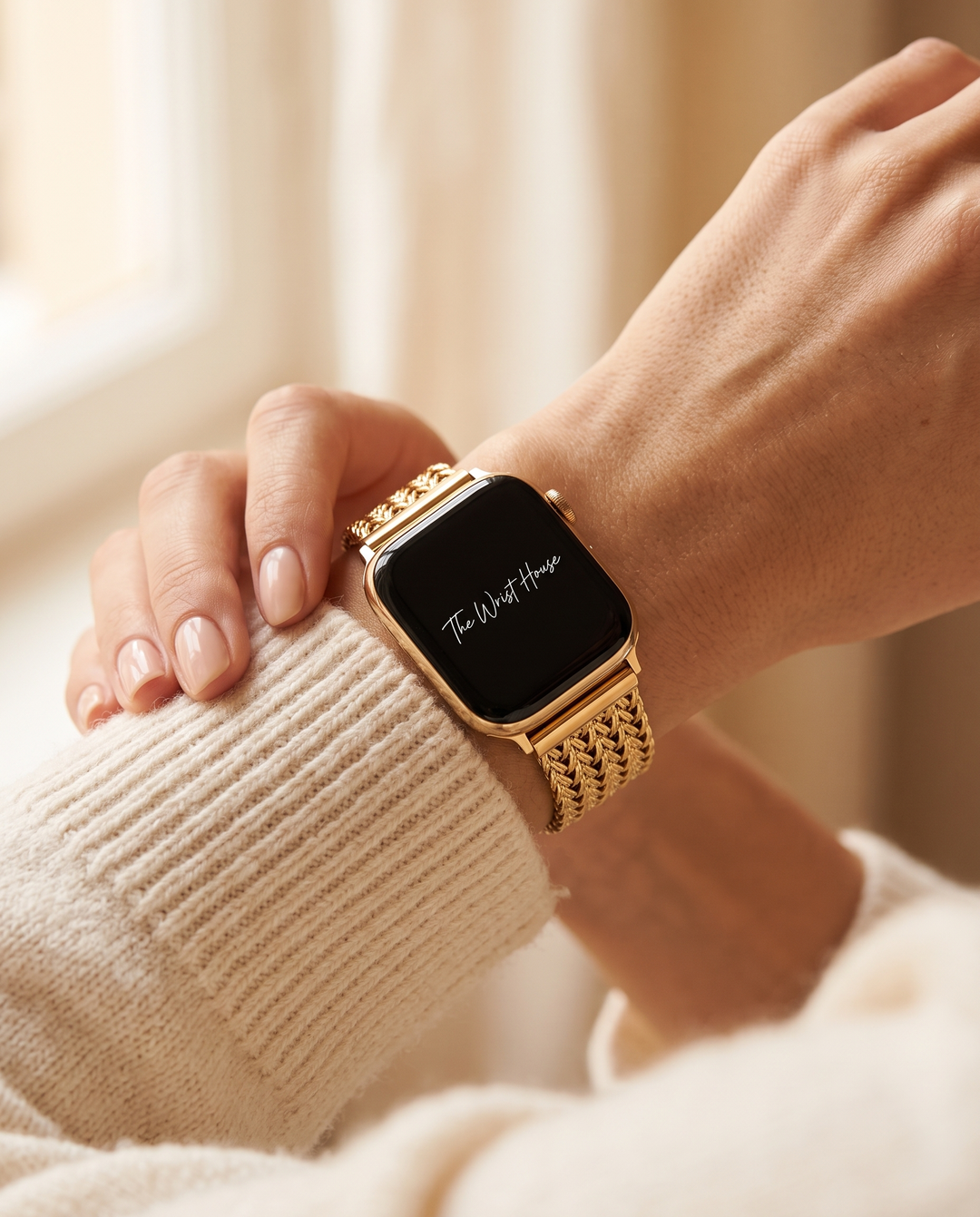 Woven chain Apple Watch band worn on a woman's wrist