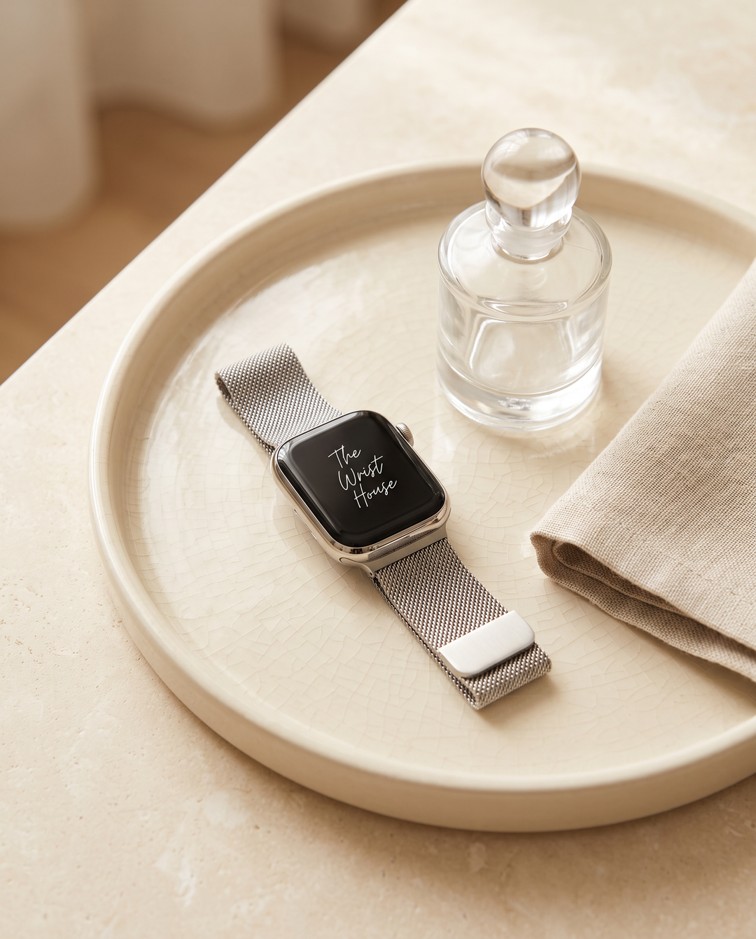 Milanese mesh band for Apple Watch on a ceramic tray